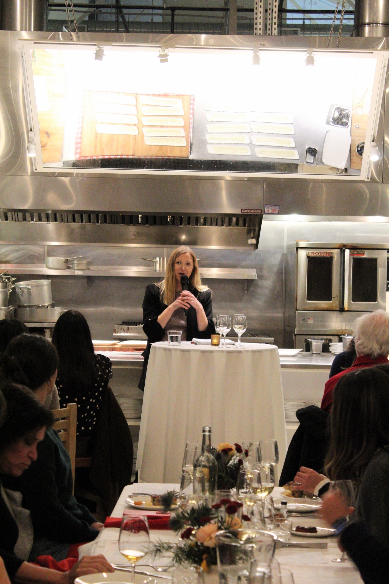 Gina speaking about wine at an event